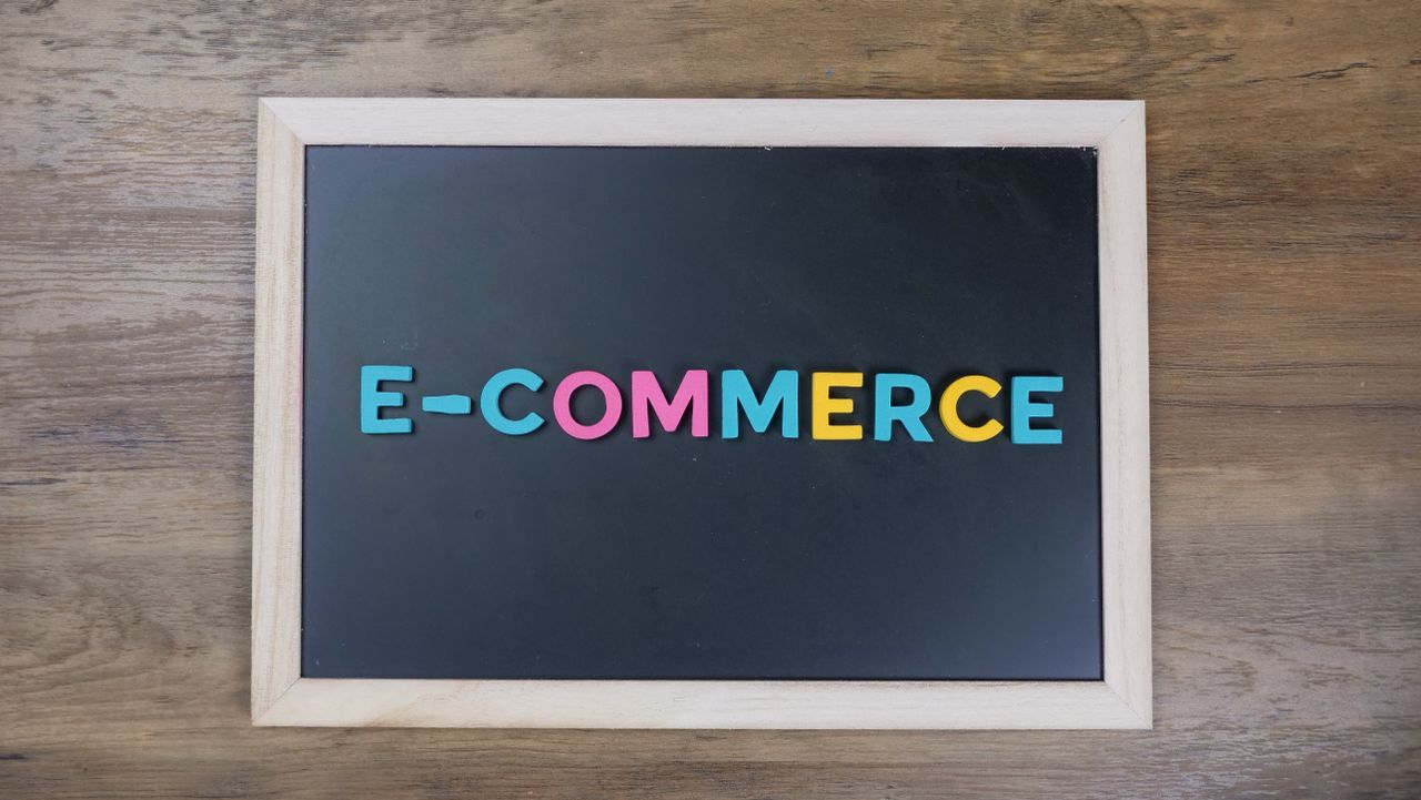 mobile-02 Colorful letters spelling 'e-commerce' on a wooden framed blackboard.